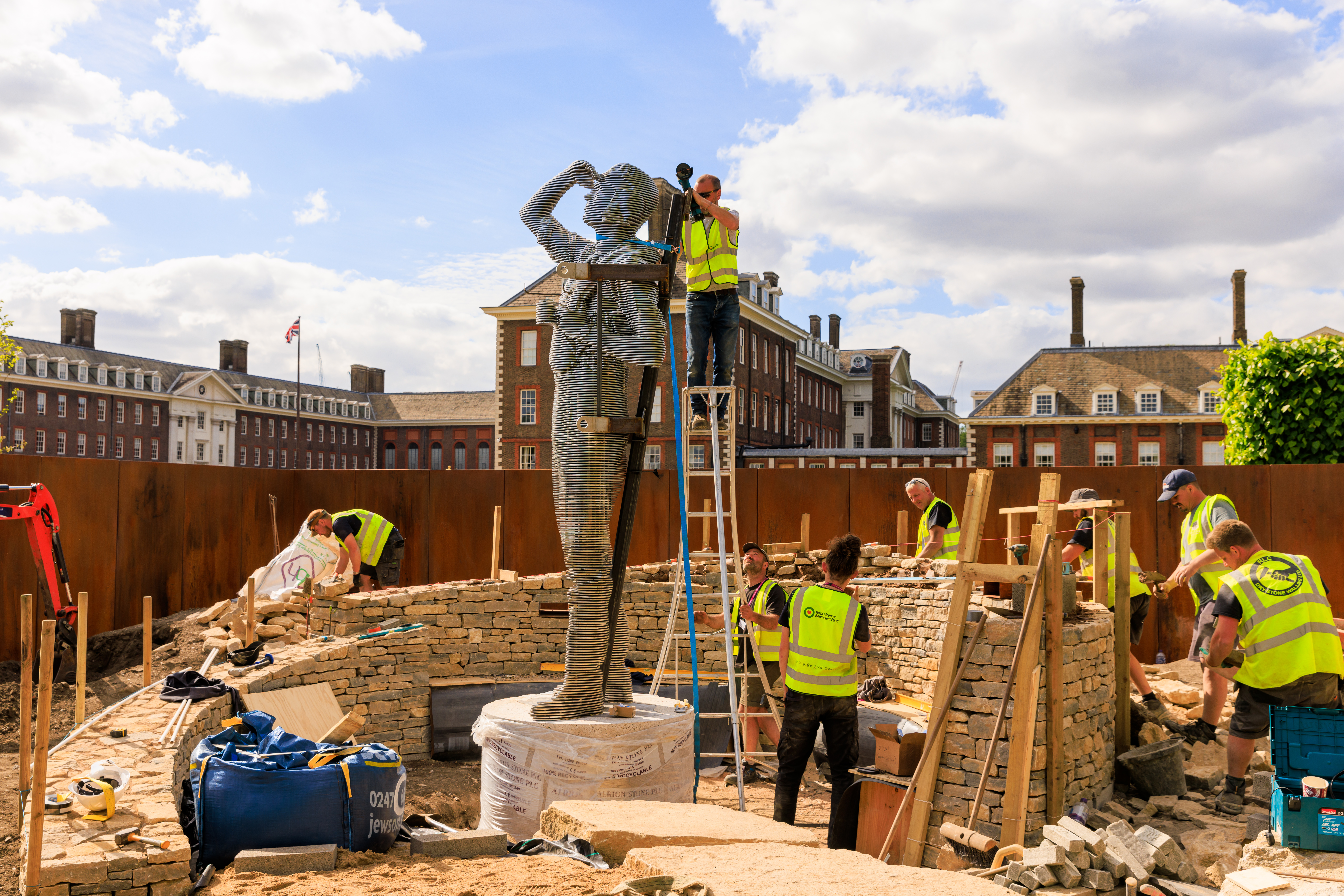 Sculpture on building site with workers.